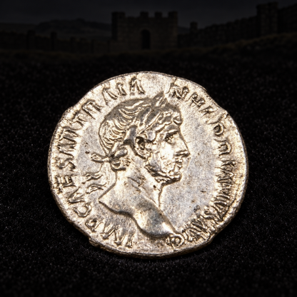 Representative Hadrian coin obverse resting on black velvet with an illustrative Roman historical background
